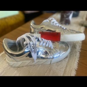 Off-white brand low vulcanized, full mirror, silver tennis shoe size 40. $99